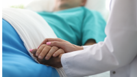 nurse holding patient hand